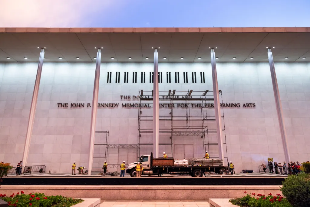 Workers prepare to remove President Donald J. Trump's name from the facade of the Kennedy Center in Washington, DC.