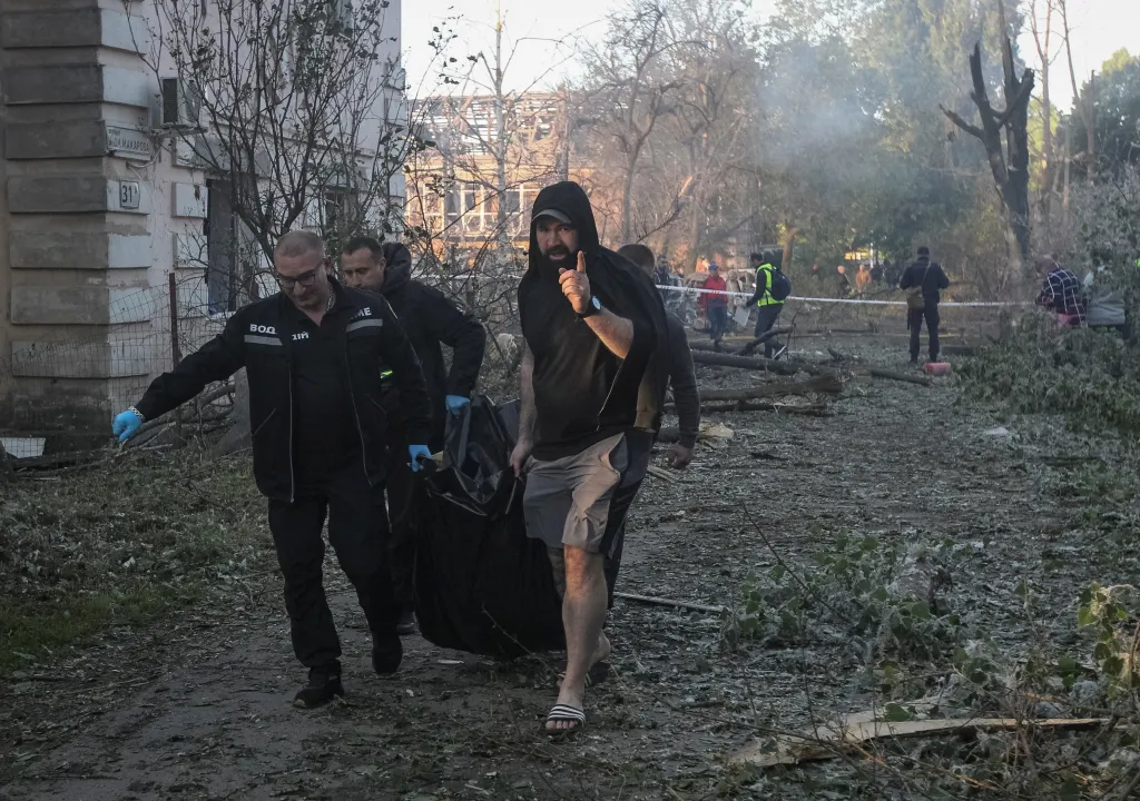 Workers and residents carry the body of a person recovered from under the debris at the site of a an apartment building damaged during a Russian drone and missile strike, amid Russia's attack on Ukraine, in Dnipro, Ukraine, on June 2, 2026.
