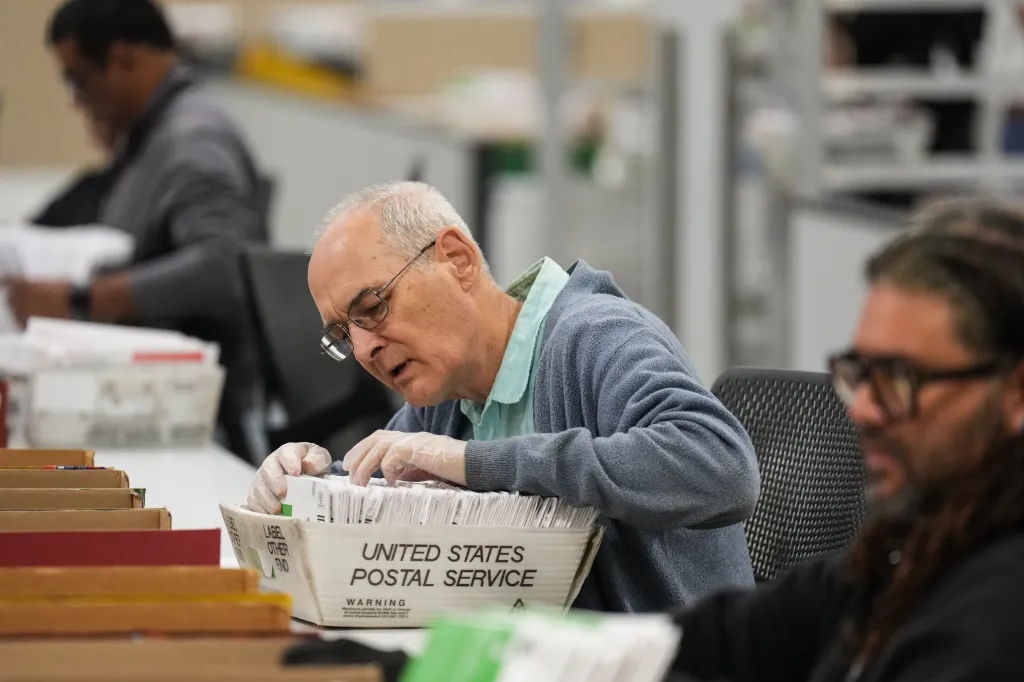 An election worker sorts ballots at the Los Angeles County Ballot Processing Center.