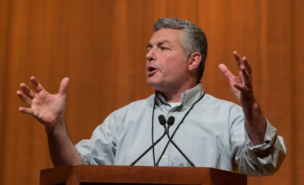 Dave Regan, president of SEIU-UHW, speaks at a podium.