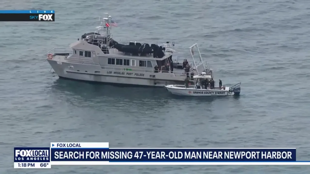 Two boats, one large and one small, are searching for a missing person near Newport Harbor.