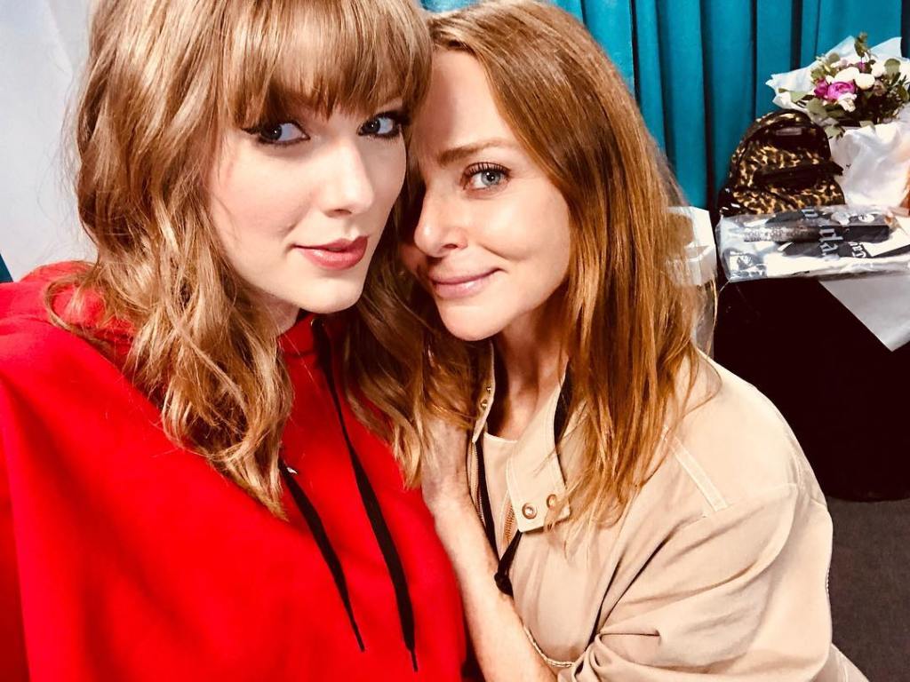 Taylor Swift and Stella McCartney smiling at the camera.