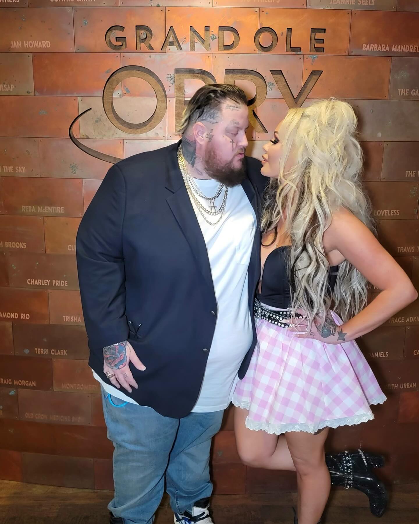Jelly Roll and Bunnie XO posing at the Grand Ole Opry.