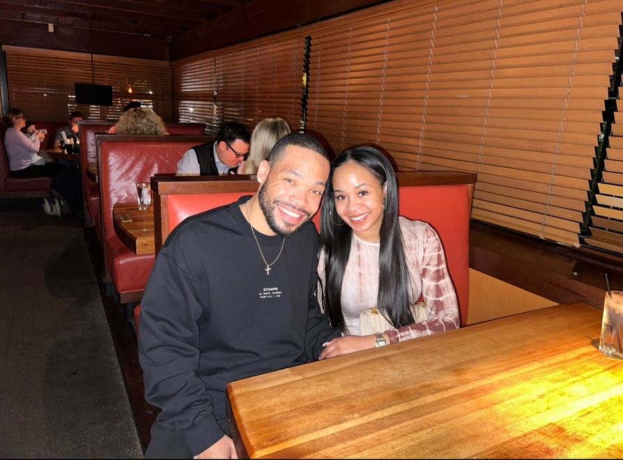 Jasmine Lawrence and Eric Murphy smiling at a restaurant.