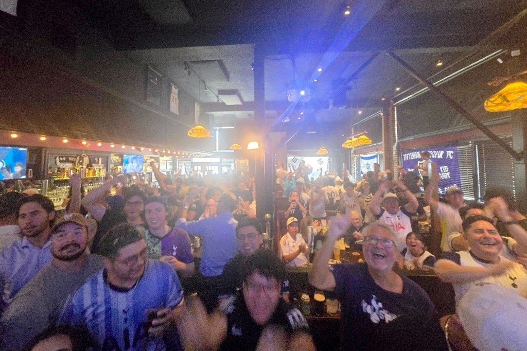 People cheering inside The Greyhound Bar & Grill.