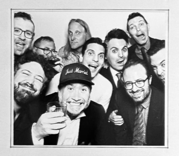 Black and white photo booth picture of the groom, Trent Olsen, in a 