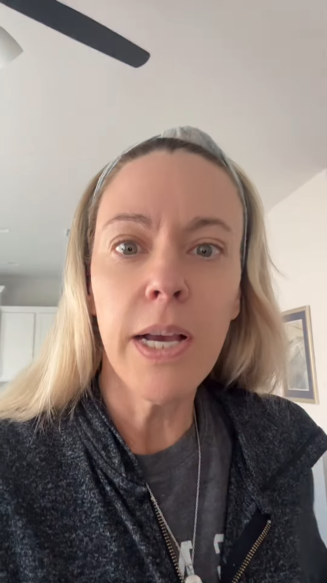 Kate Gosselin looking directly at the camera with her mouth slightly open.