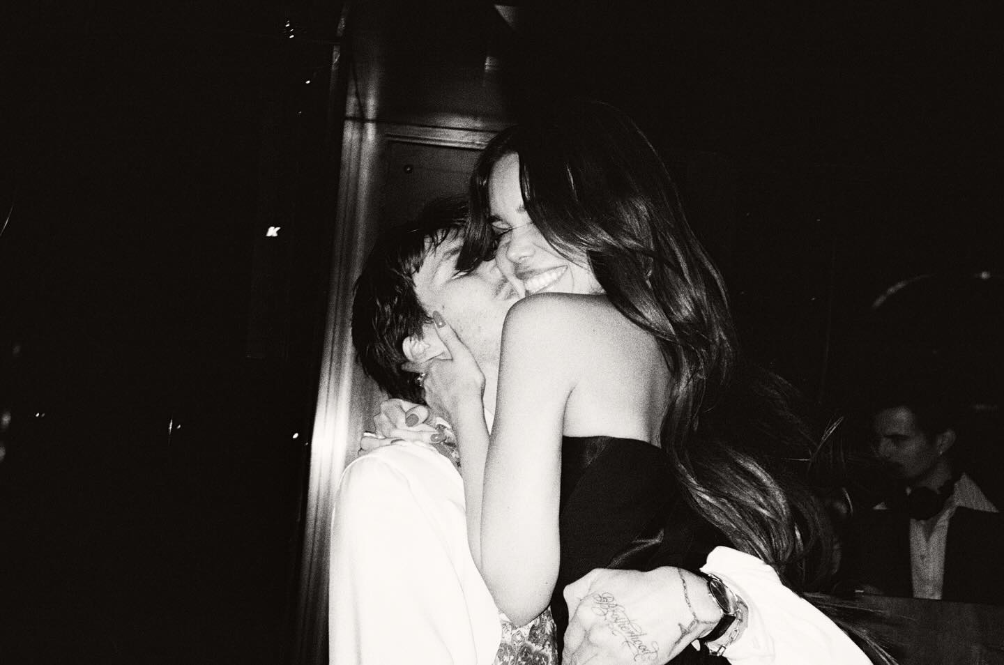 Cruz Beckham and Jackie Apostel embrace each other in a black and white photo.