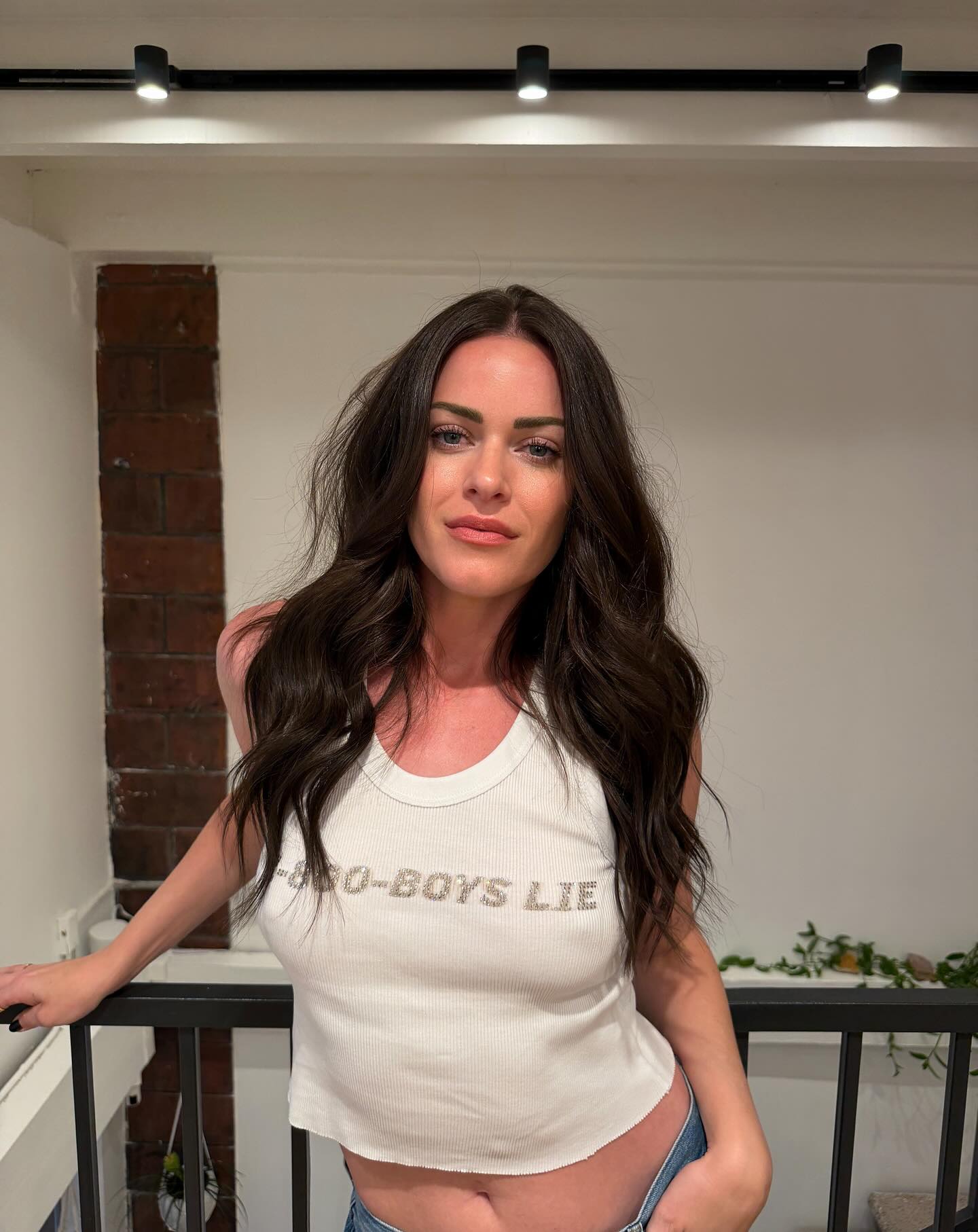 Dayna Kathan in a white tank top with