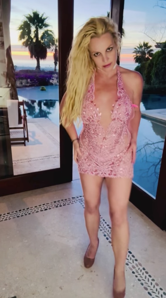 Britney Spears dancing in a pink dress.
