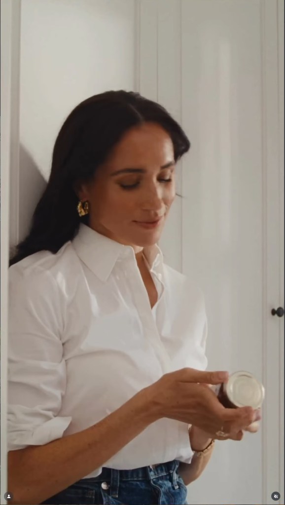 Meghan Markle holding a jar of jam.