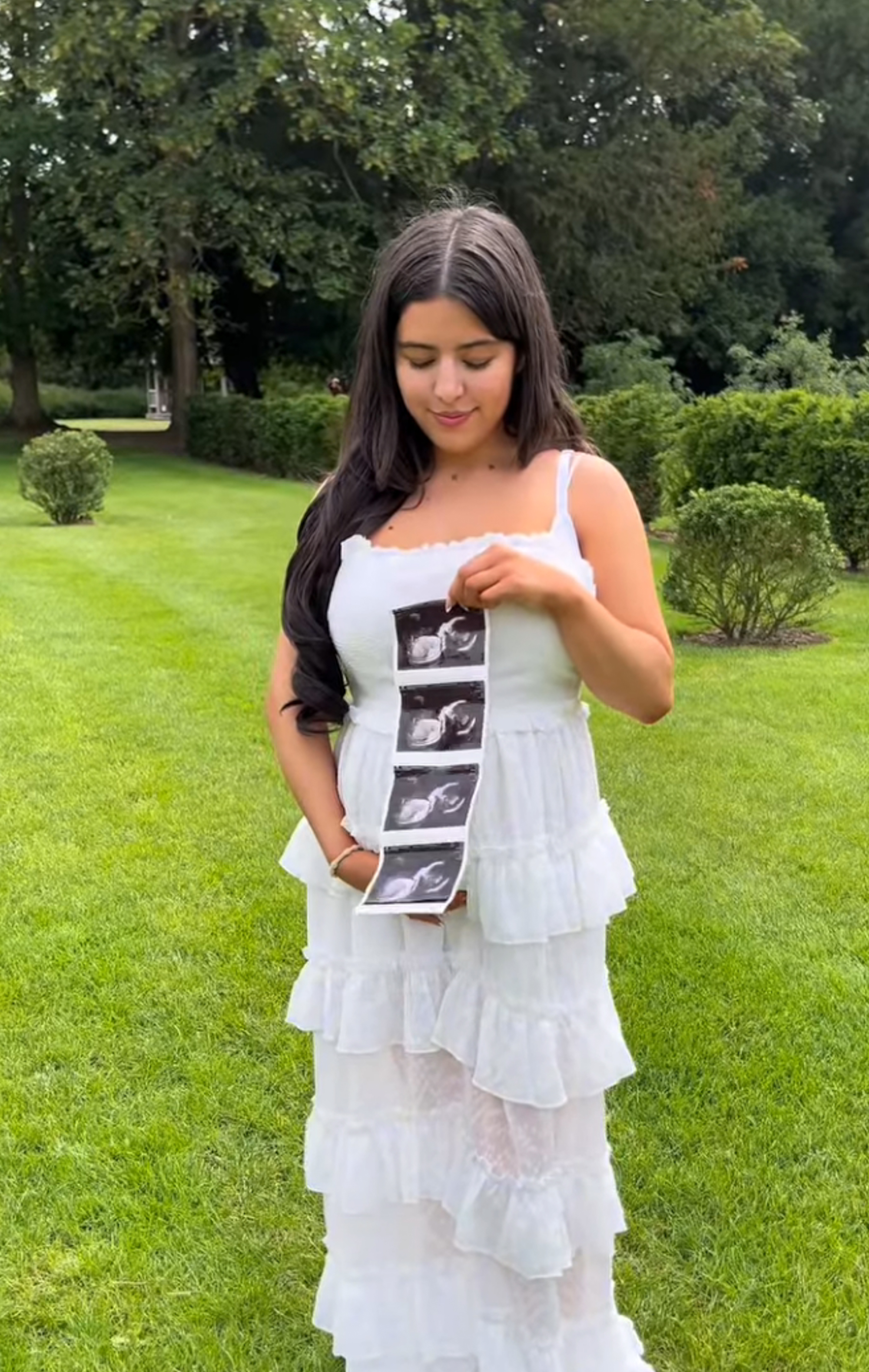 Sophia Grace Brownlee posing with a strip of four ultrasound photos, announcing her pregnancy.