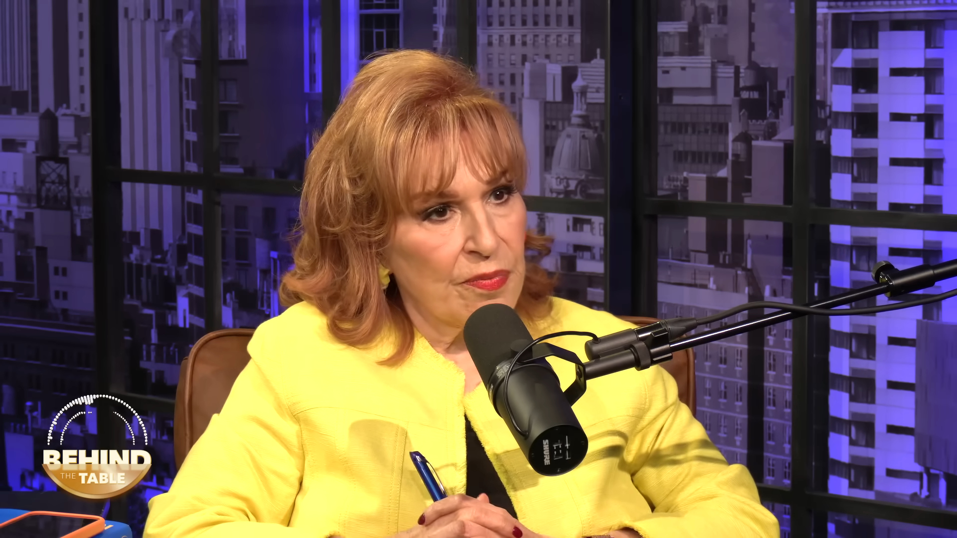 Joy Behar speaking into a microphone during the