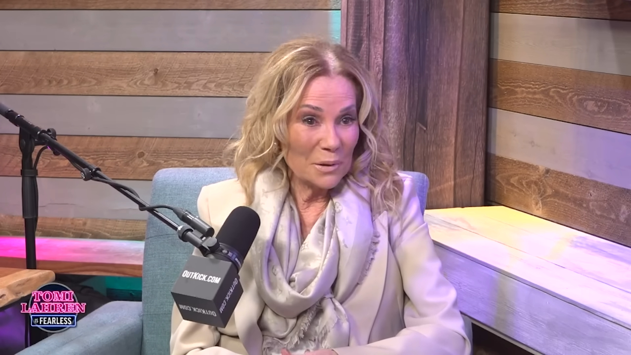 Kathy Lee Gifford sitting in a chair, talking into a microphone.