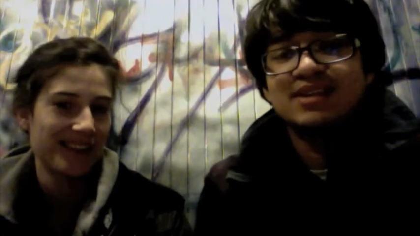 Marie Gluesenkamp Perez, wearing a dark hooded top, smiles at the camera next to a man in glasses.