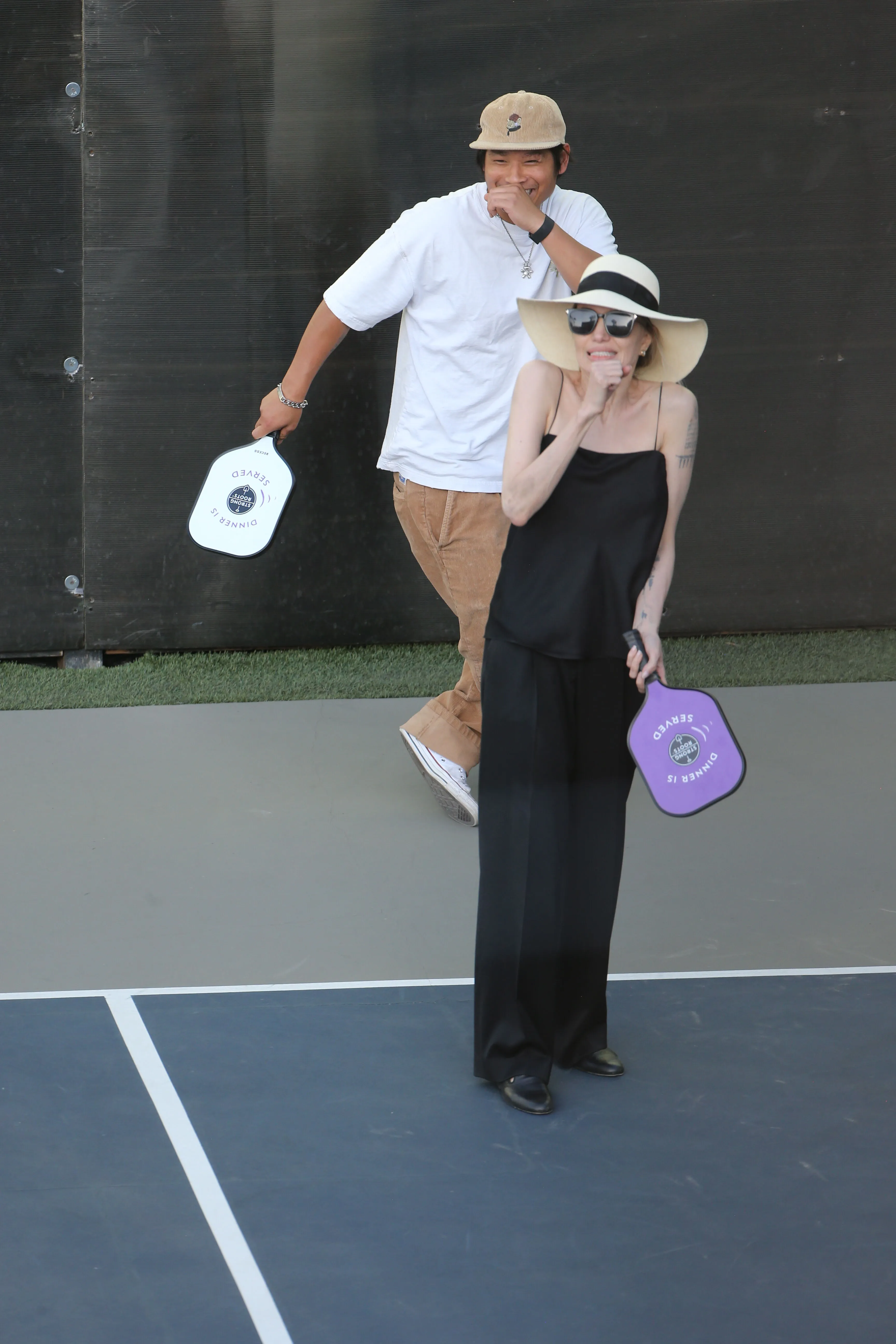 Angelina Jolie playing pickleball with a man.