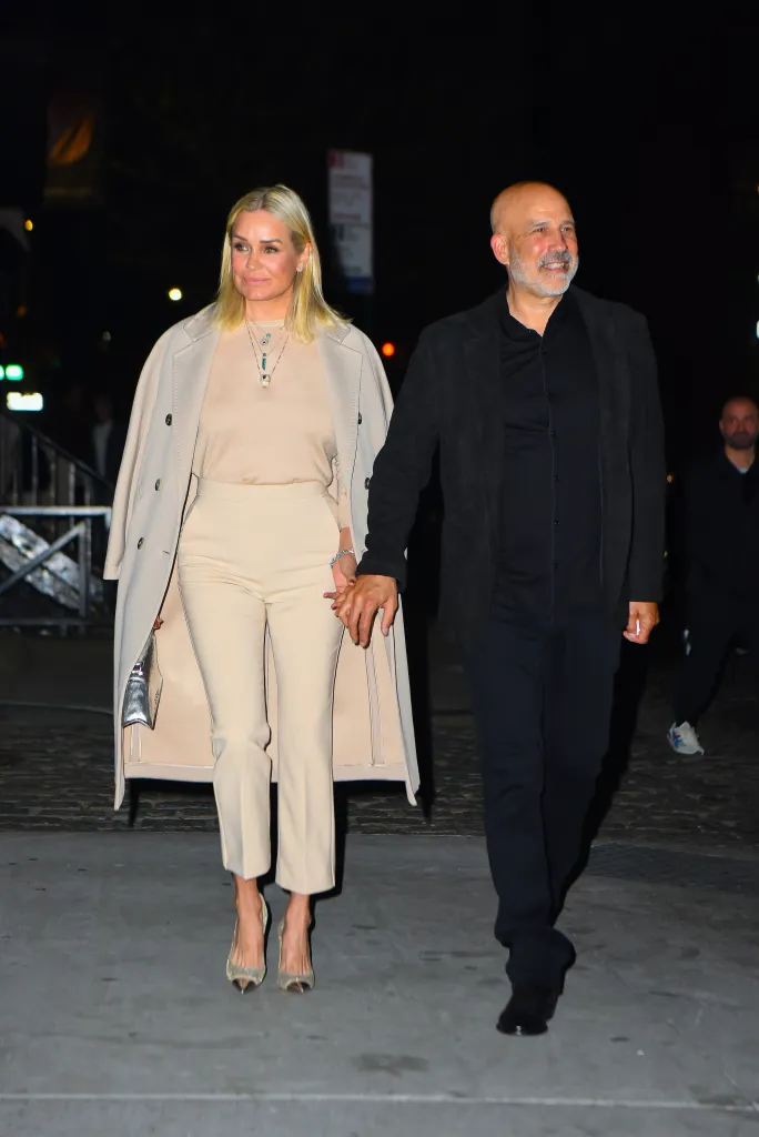Yolanda Foster Hadid and Joseph Jingoli holding hands.
