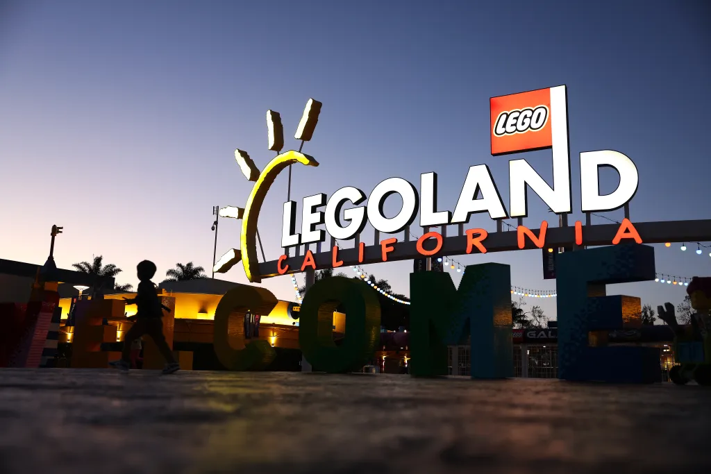 A young visitor runs past the front entrance to Legoland in Carlsbad, California.