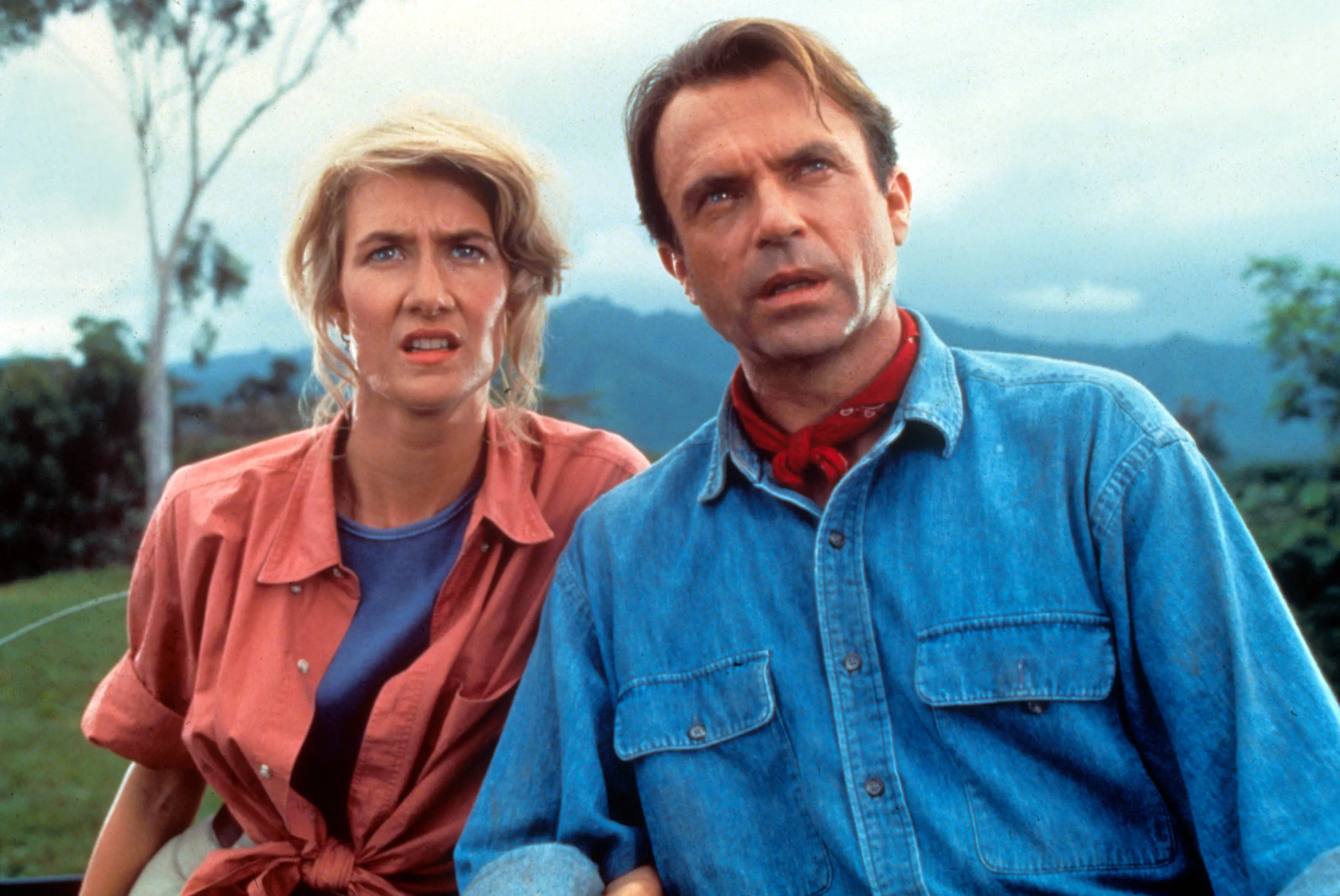 Laura Dern and Sam Neill look up in fear in Jurassic Park (1993).