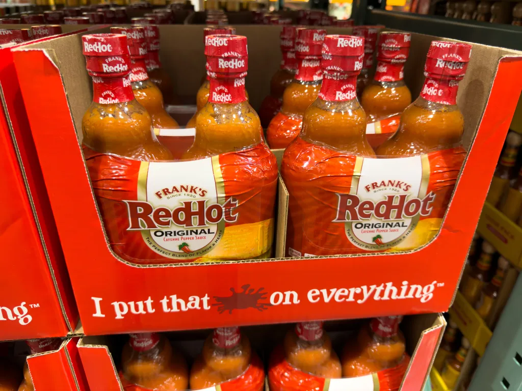 Retail display of Frank's RedHot Original Cayenne Pepper Sauce bottles.
