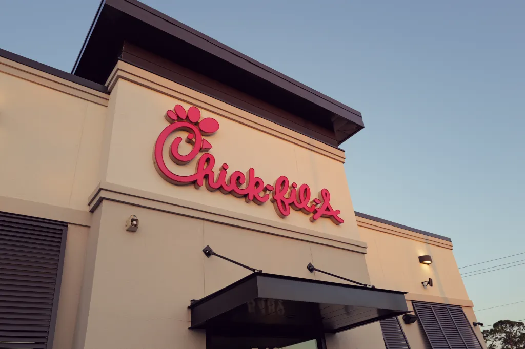 The Chick-fil-A sign, featuring the company's distinct red lettering with a chicken head forming the 