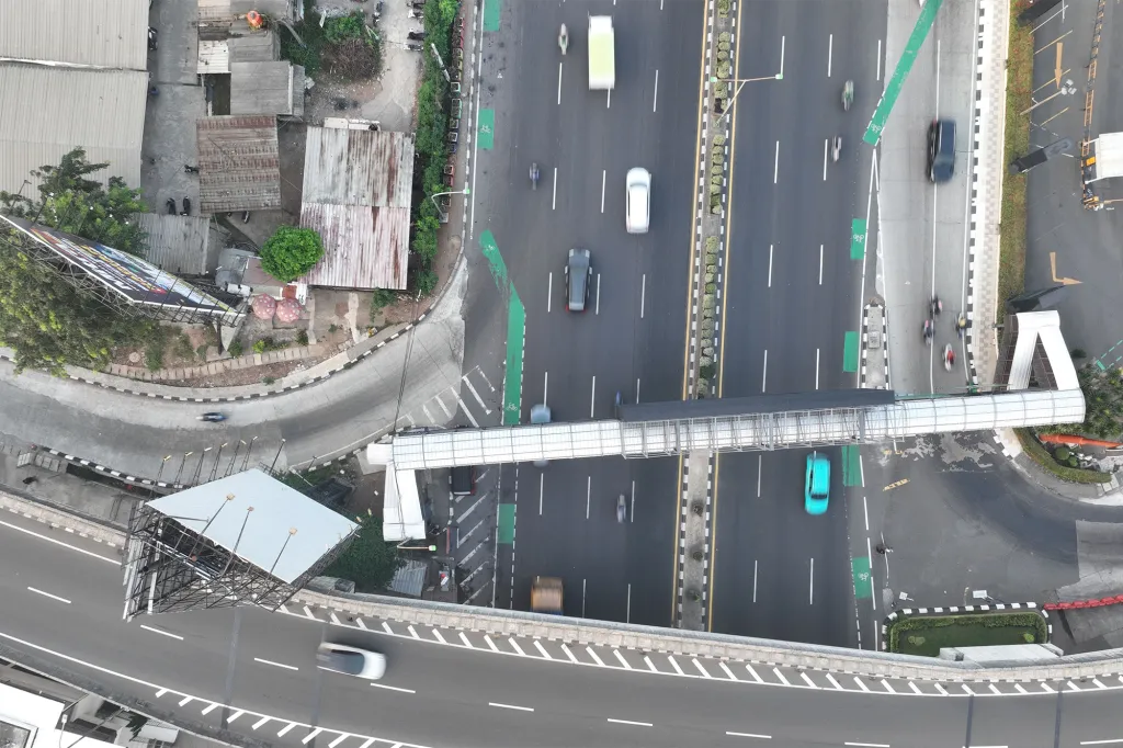 A pickup truck carrying wedding guests was crushed between two trucks on a busy highway on Indonesia's main island of Java, killing 13 people and injuring five others, police said Monday.