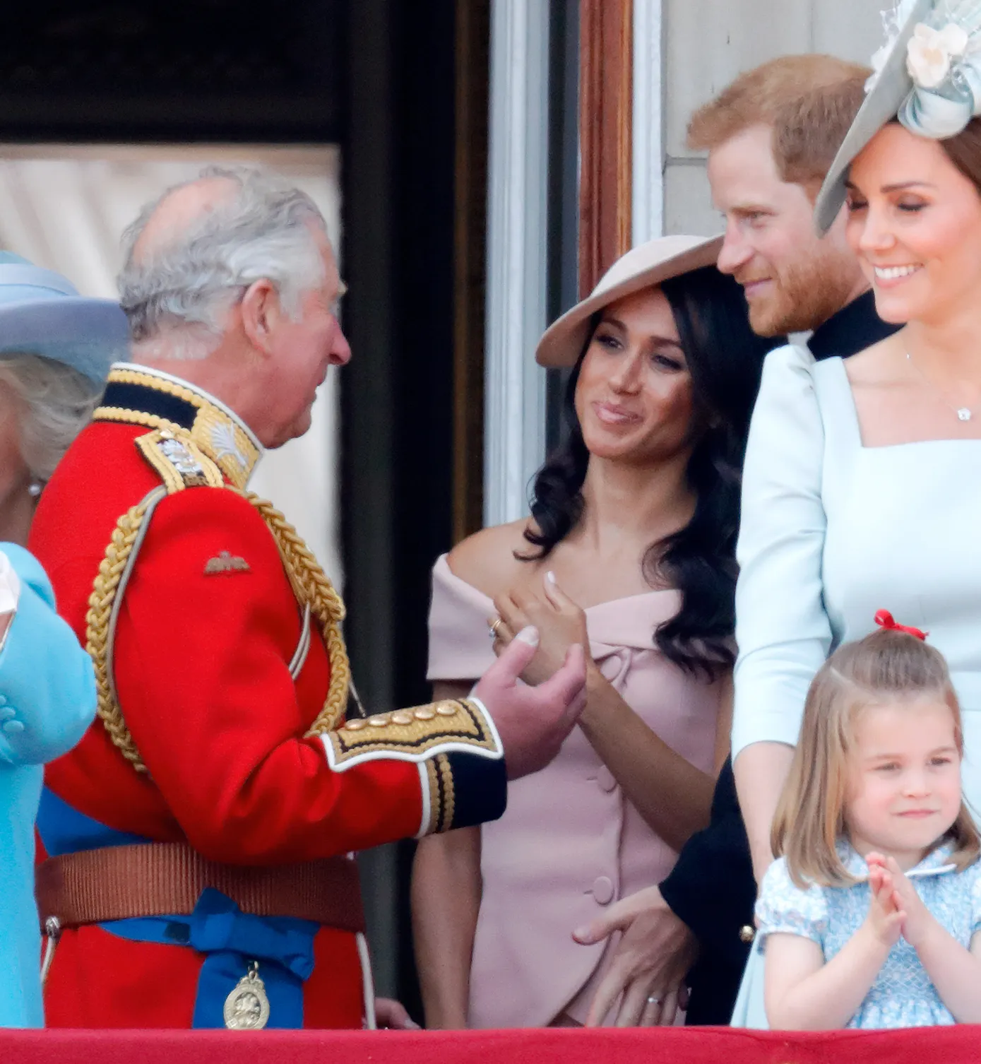 King Charles, Meghan Markle, Prince Harry, Kate Middleton, and Princess Charlotte on the Buckingham Palace balcony.