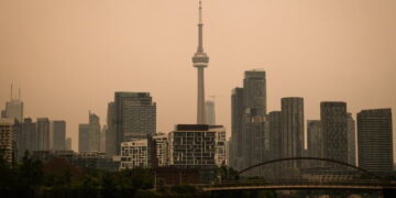 Toronto Under an Orange Sky as Wildfire Smoke Pours Into the U.S. Northeast