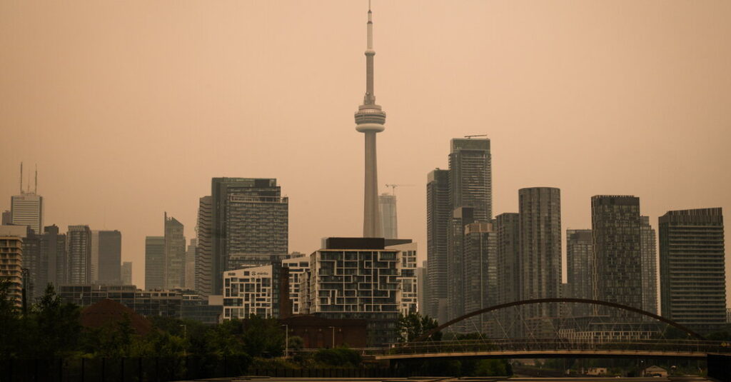 Toronto Under an Orange Sky as Wildfire Smoke Pours Into the U.S. Northeast