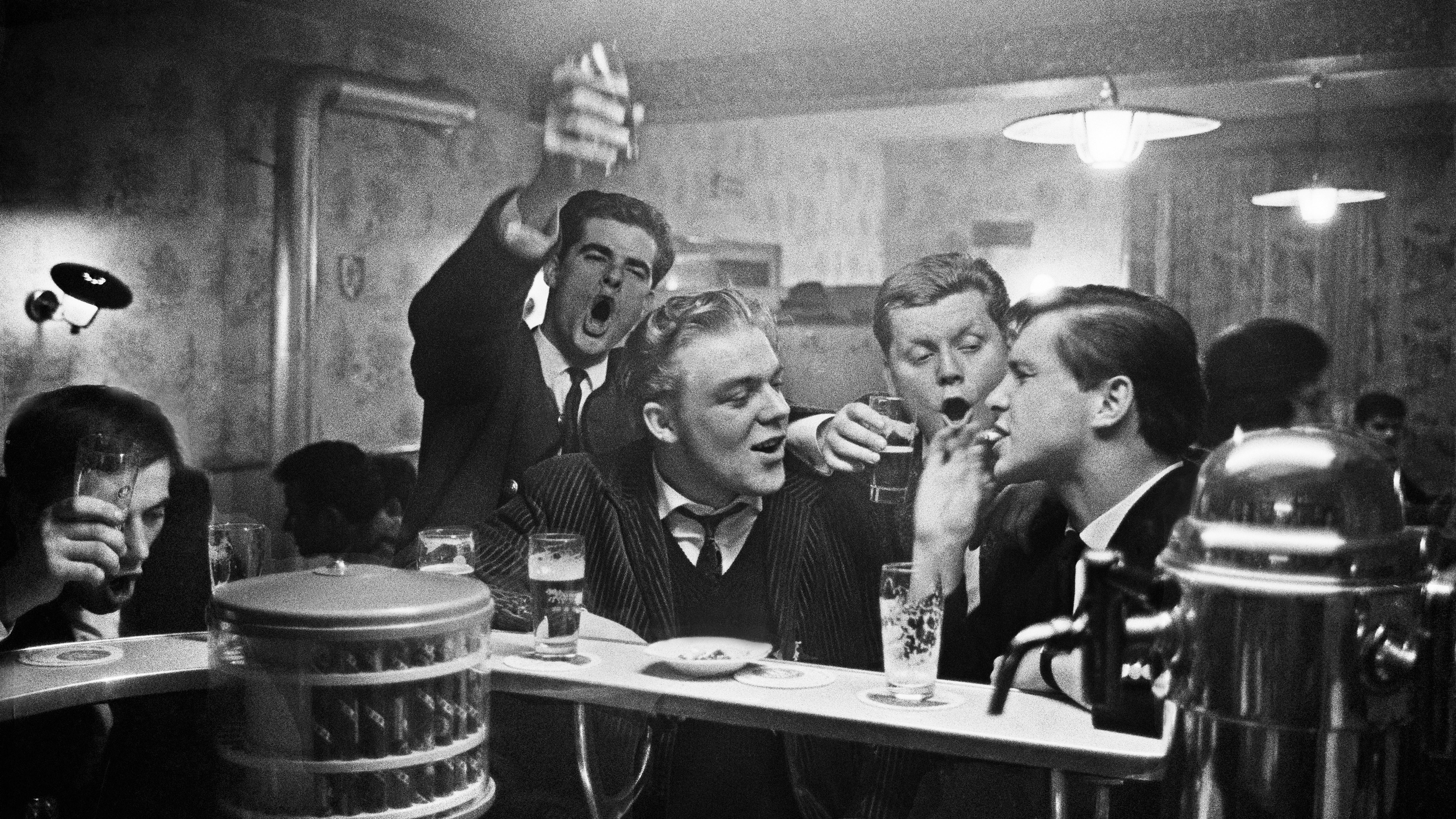 Black-and-white photo of men at a bar