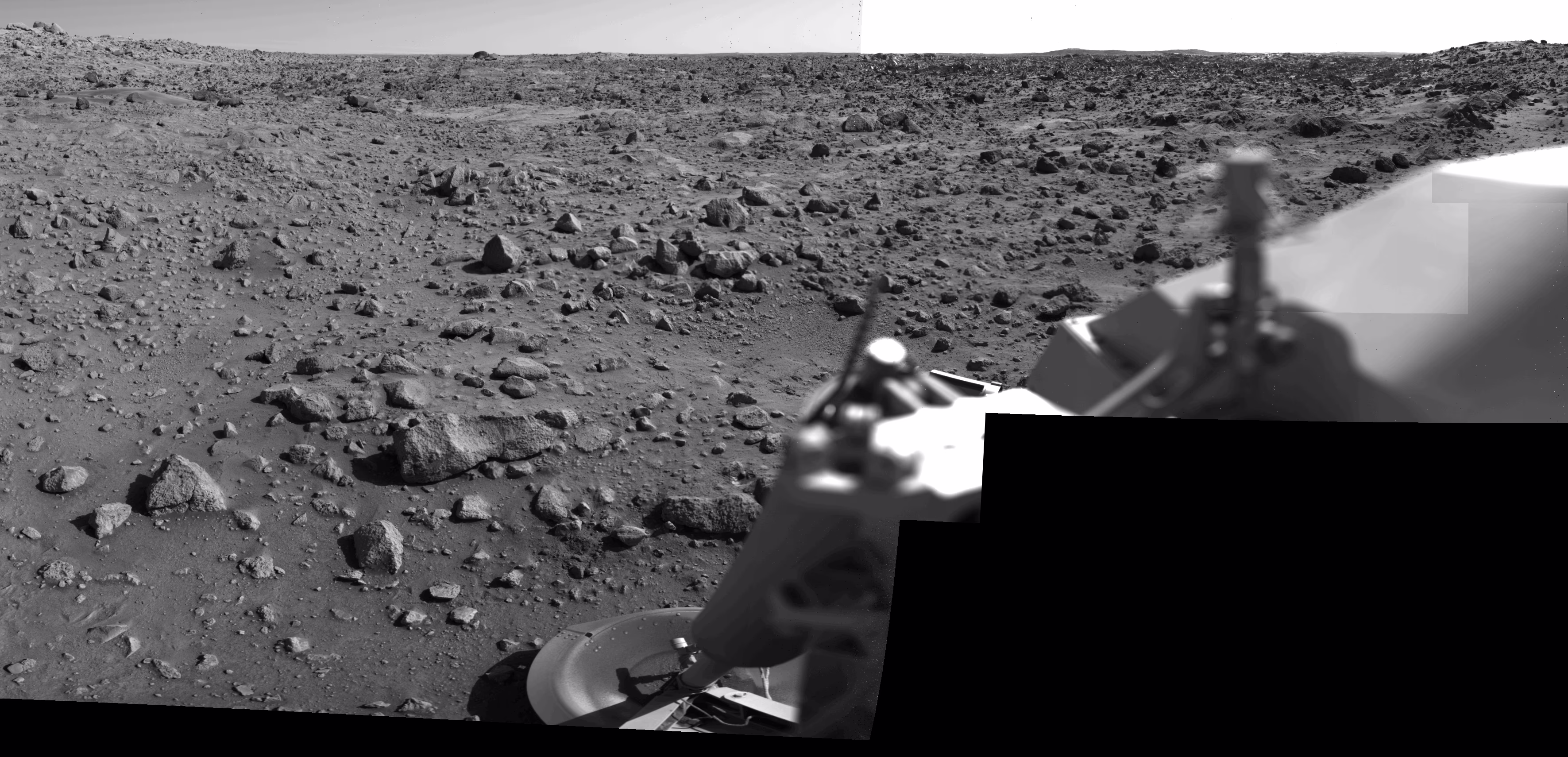 A panoramic view of the surface of Mars, with part of Mars Lander spacecraft seen in the foreground.