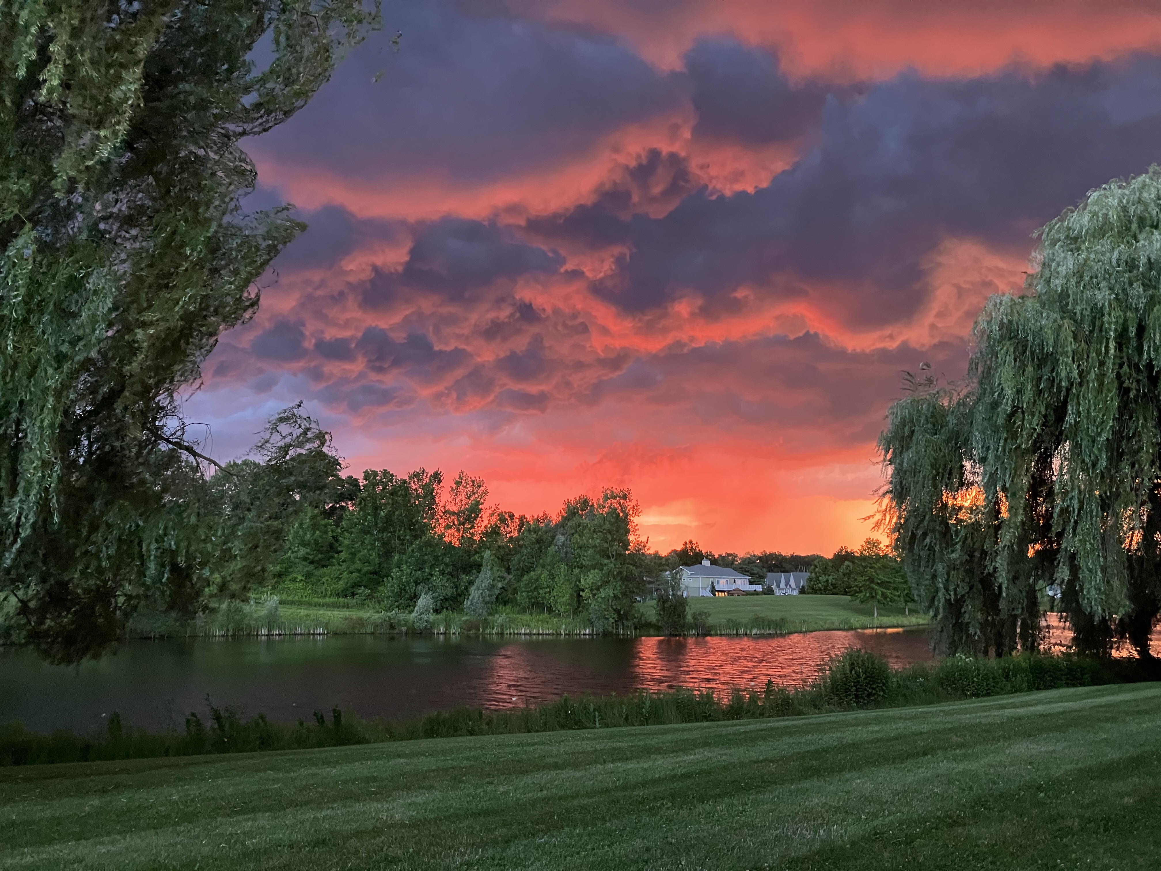 A photo of a sunset next to a lake