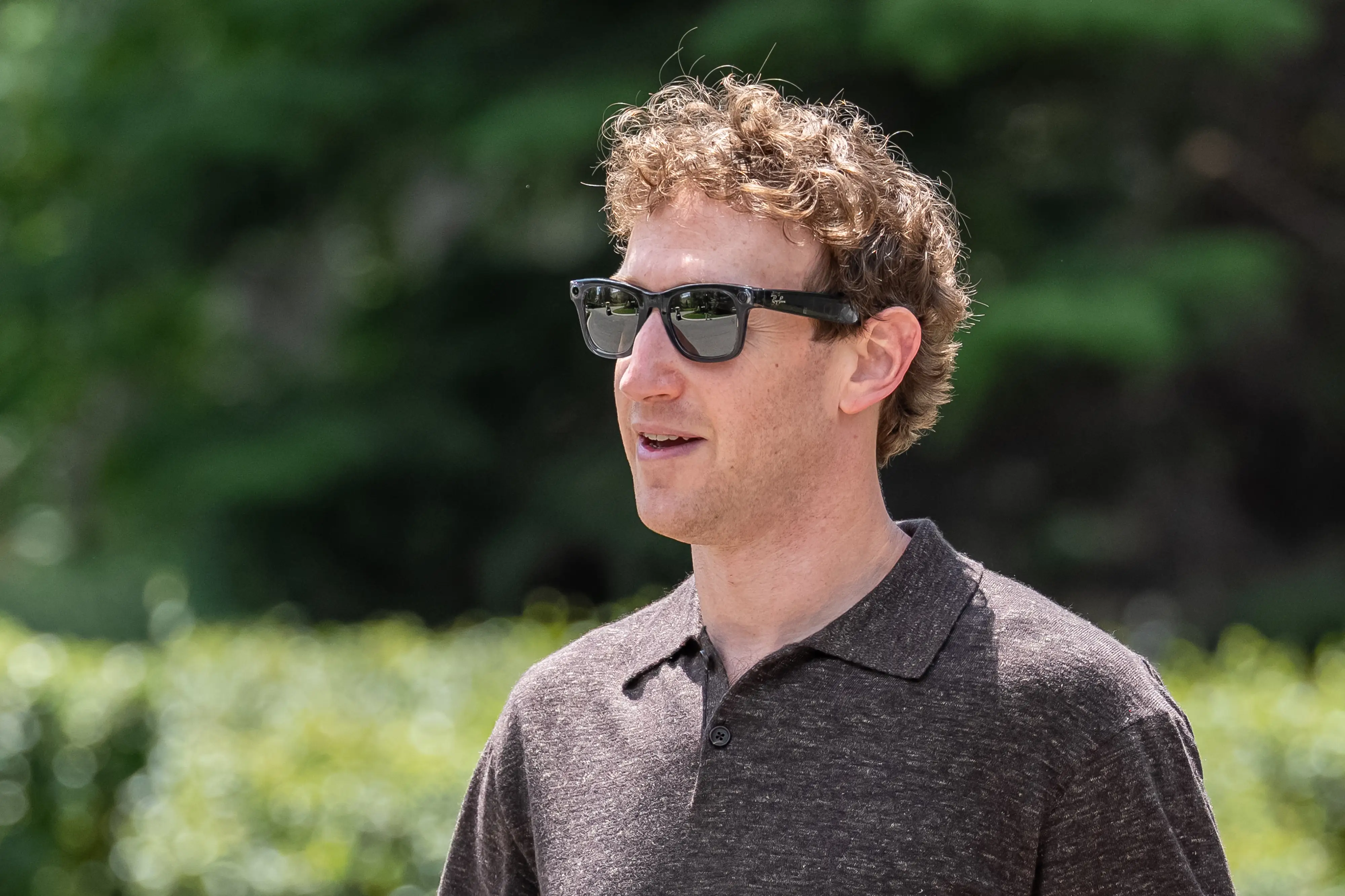 Mark Zuckerberg, CEO of Meta Platforms Inc., is wearing the Meta Ray-Ban glasses while walking outside.