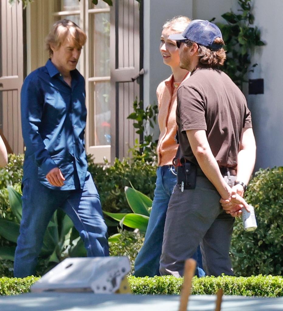 Owen Wilson, Apple Martin, and a crew member on the set of 