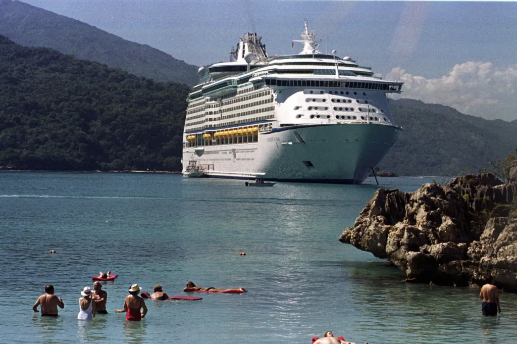 Royal Caribbean cruise ship anchored off Labadee Beach, Haiti, with passengers in the water.