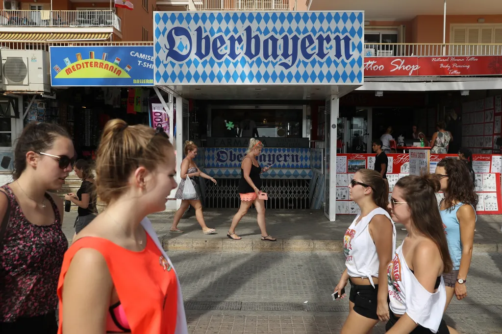 People walking past the Oberbayern disco in Palma de Mallorca.
