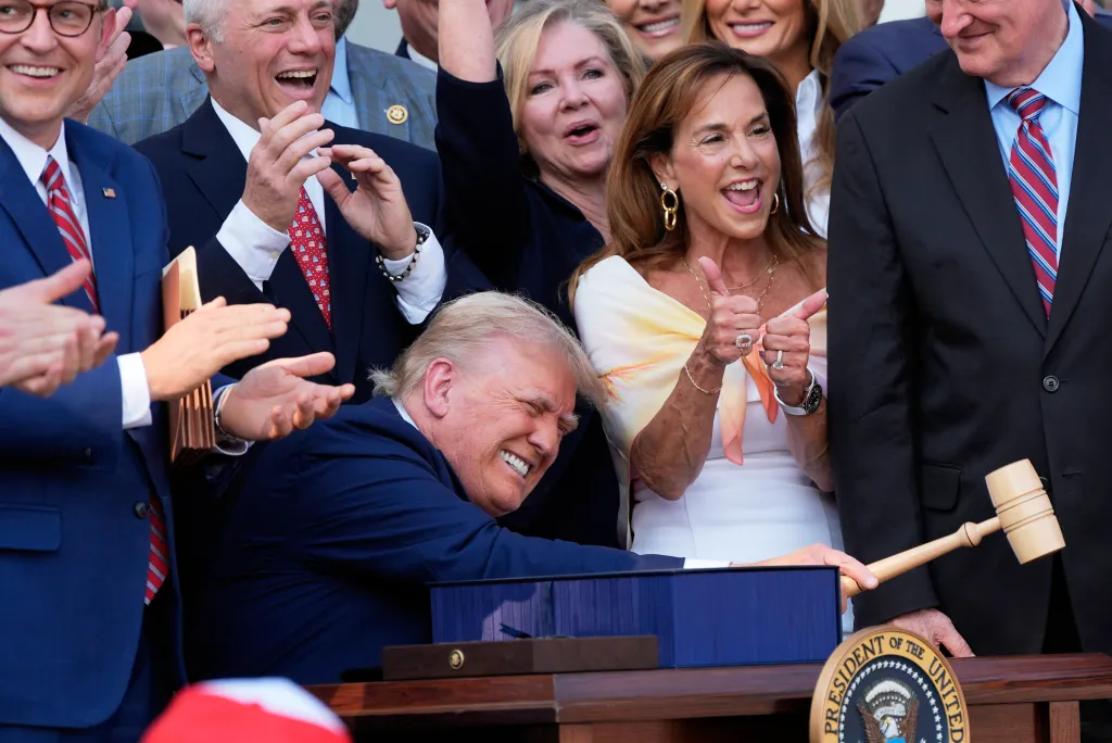 President Donald Trump bangs a gavel after signing the 