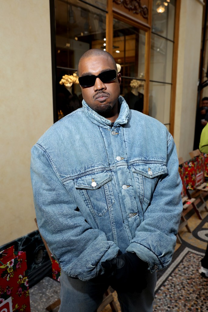 Ye in a denim jacket, sunglasses, and black gloves.