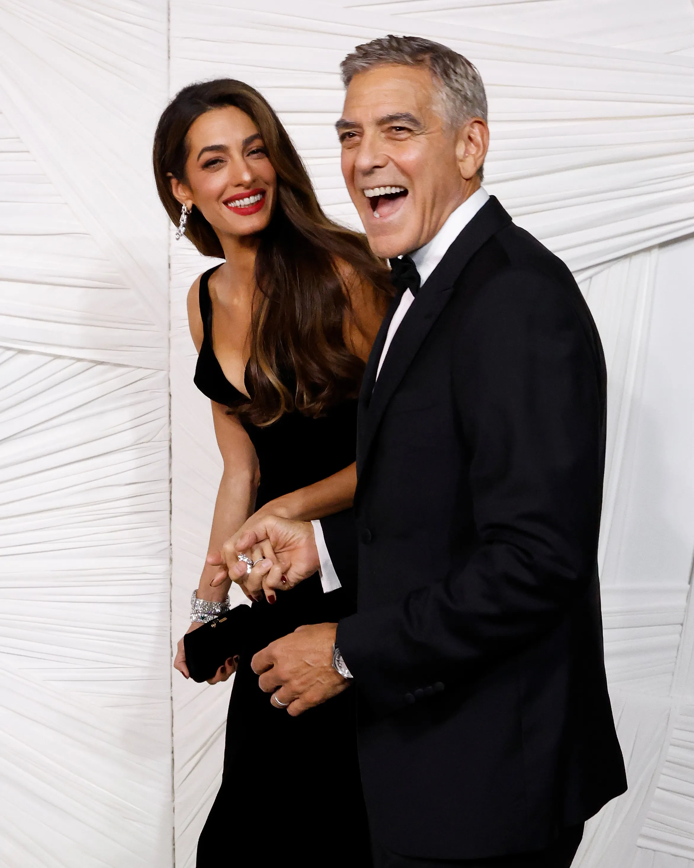 Amal and George Clooney laughing at the 2024 Albie Awards.
