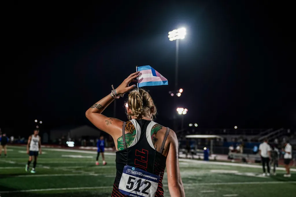 Sadie Schreiner with a transgender flag in her hair after finishing 3rd in the finals of the 200m race at the 2024 NCAA DIII outdoor track and field championships.