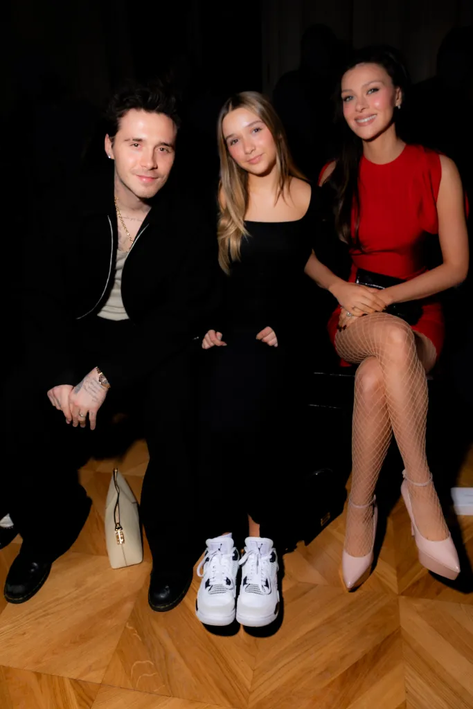 Brooklyn Beckham, Harper Beckham, and Nicola Peltz Beckham at the Victoria Beckham RTW Fall 2024 show.