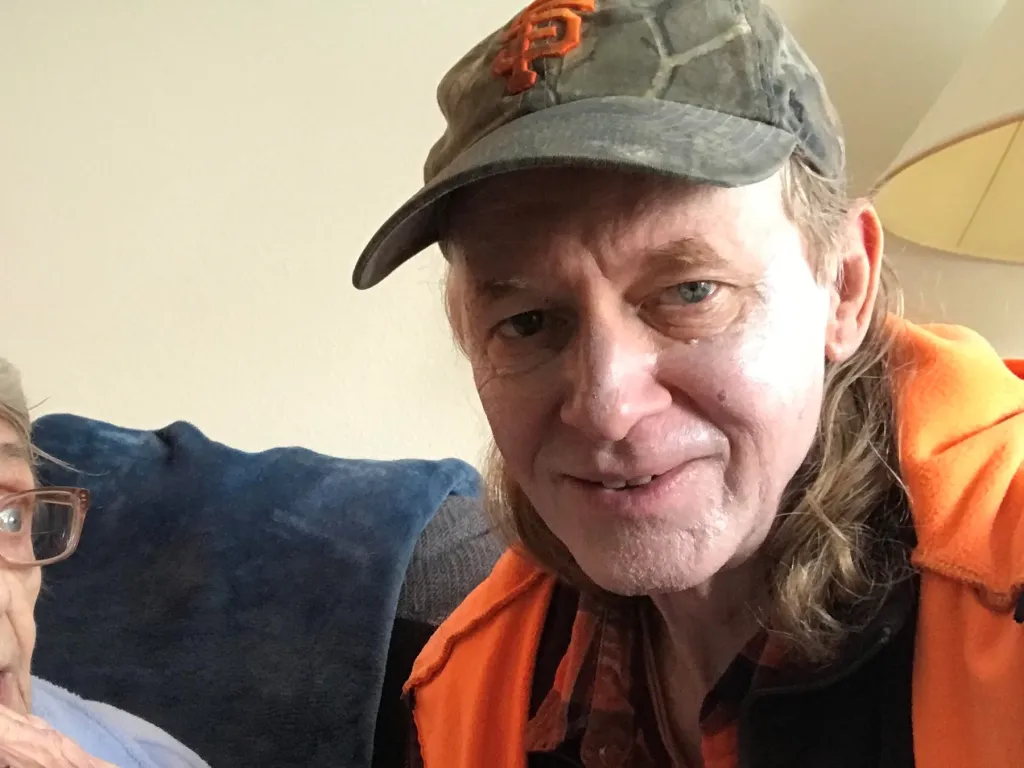 Steven Bassett wearing a camouflage cap with an orange 
