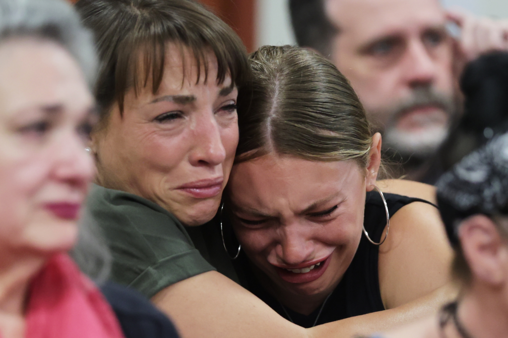 Dylan Mortensen, comforted by another woman, cries at Bryan Kohberger's sentencing hearing.