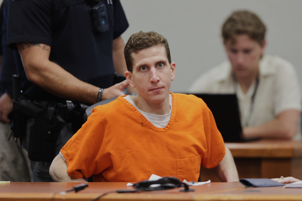Bryan Kohberger in an orange jumpsuit, looking at the camera in court.