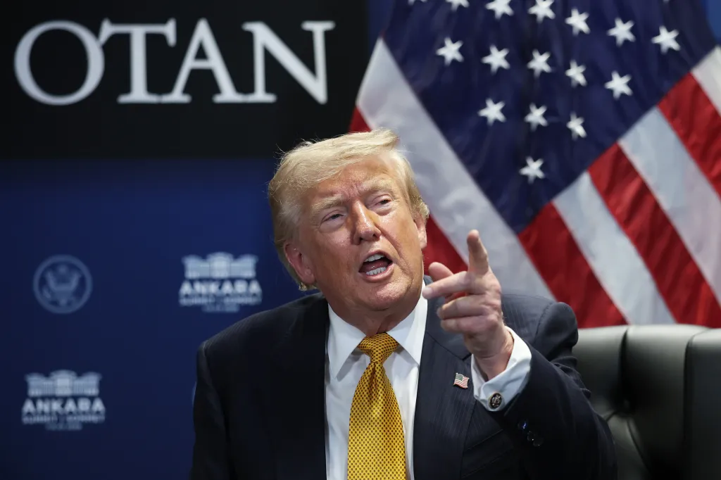 US President Donald Trump speaks at the NATO Summit in Ankara, with a US flag and 