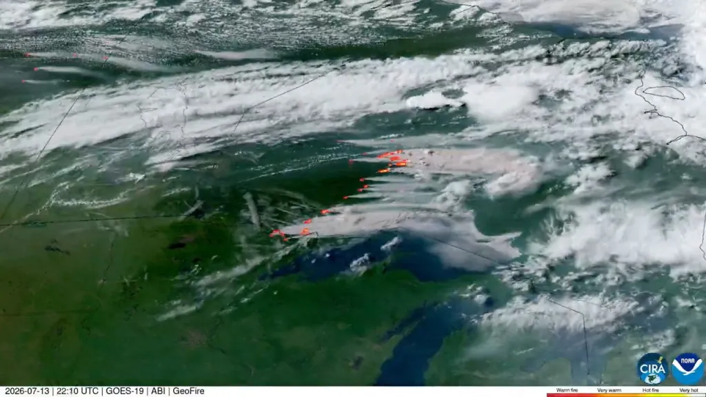 A satellite image shows wildfires spreading through northern Minnesota and Ontario, Canada, on July 13, 2026.