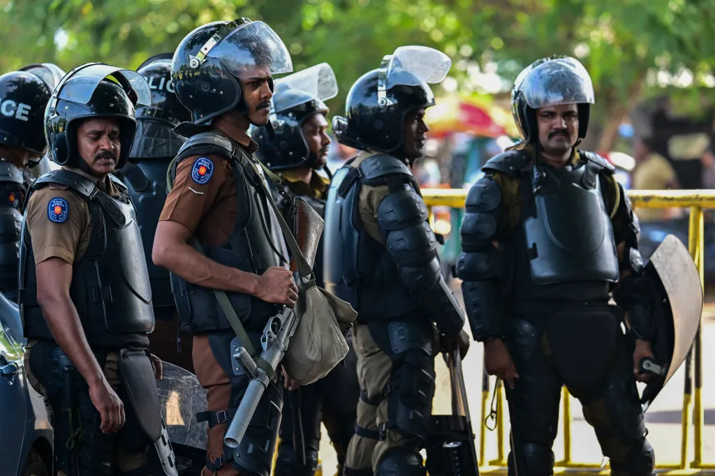 Sri Lankan police personnel stand guard outside the Negombo prison.