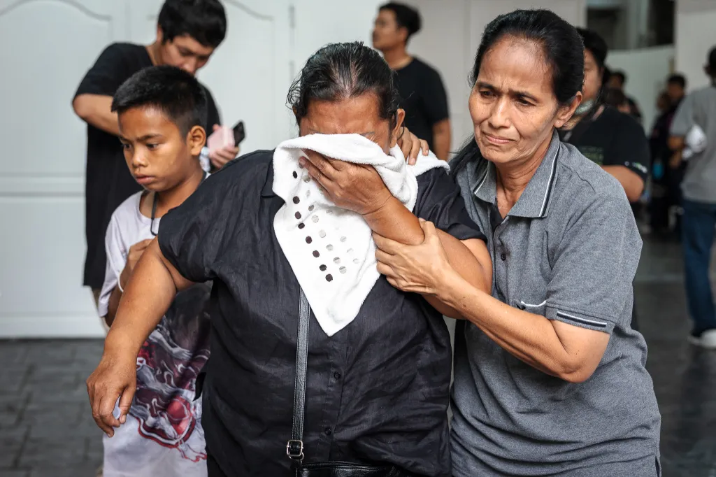 Relatives mourn victims killed in a bar fire at the Police General Hospital in Bangkok on July 14, 2026. 