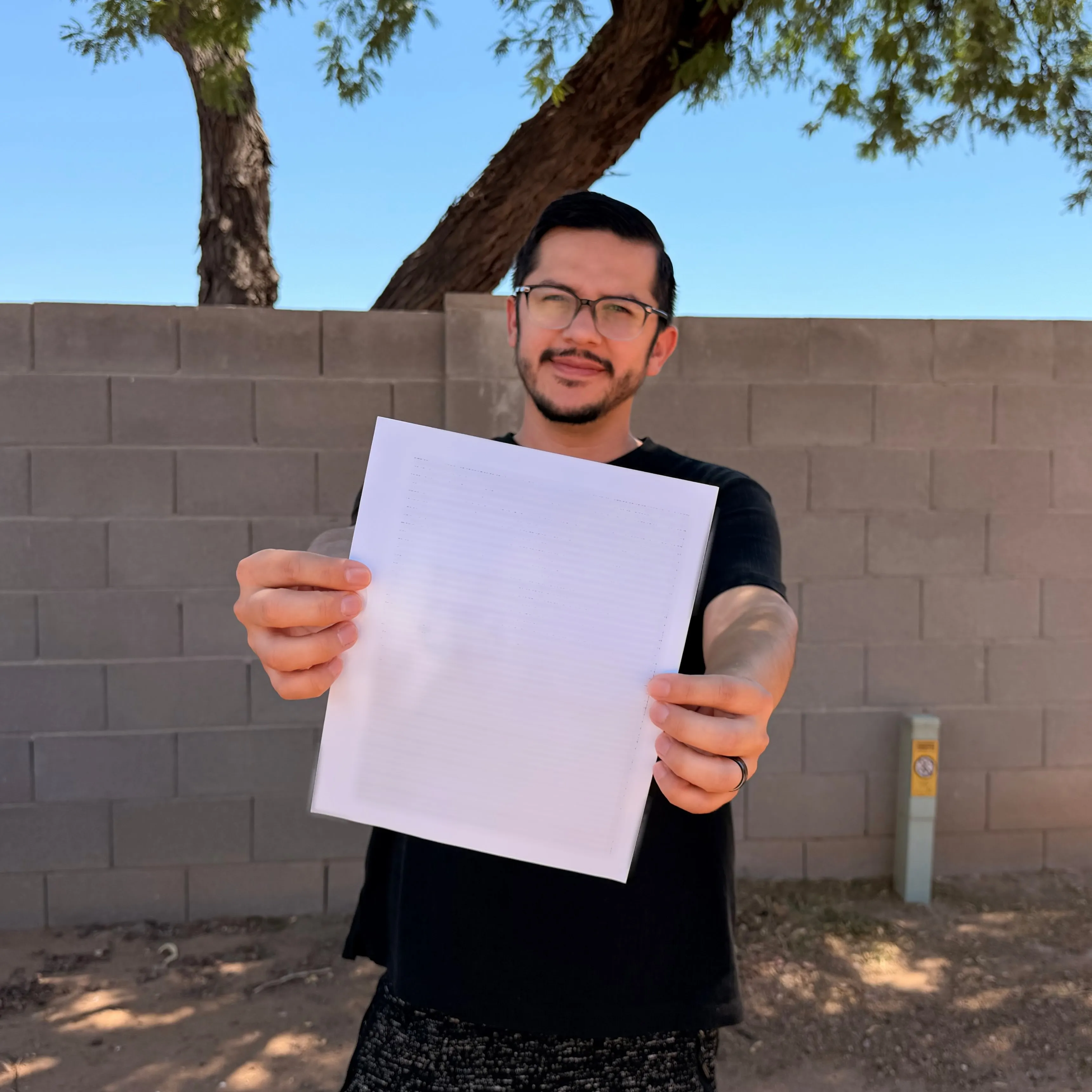Armando Rubio holding a piece of paper that reads 