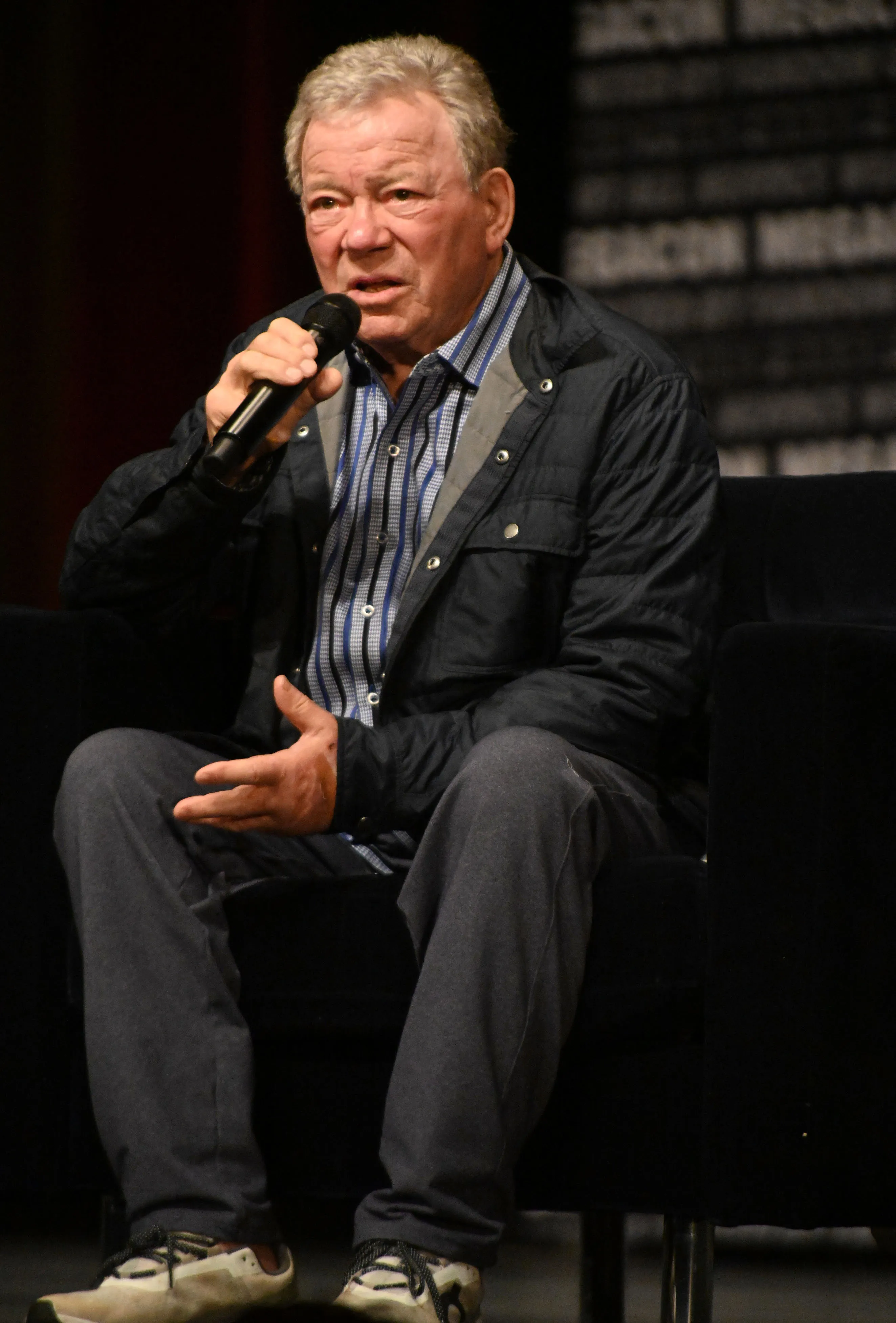 William Shatner speaking into a microphone.
